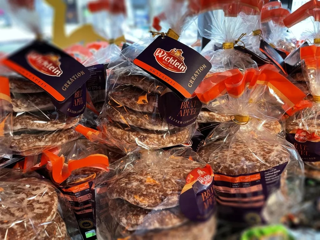 Wicklein Creation baked apple Elisen gingerbread, stacked with hang tag and orange bow in-store